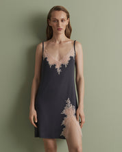Effetto bamboo chemise spaghetti strap 03162 – women's sleepwear, smoke grey
Woman wearing a navy slip dress with lace details against a green background