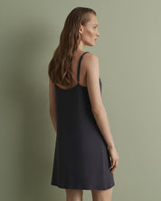 Effetto bamboo chemise spaghetti strap 03162 – women's sleepwear, smoke grey
Woman wearing a black slip dress against a green background