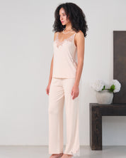 Effetto bamboo camisole pajama set 03163 – women's sleepwear, rosy peach
Woman wearing a light pink lace top and pants in a minimalistic room.