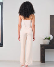 Effetto bamboo camisole pajama set 03163 – women's sleepwear, rosy peach
Woman wearing a beige sleeveless top and pants in a minimalistic room.