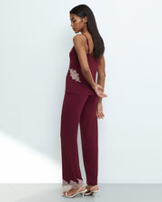 Effetto bamboo camisole pajama set 03163 – women's sleepwear, cherry lacquer
Woman wearing a burgundy jumpsuit with lace details on a white background