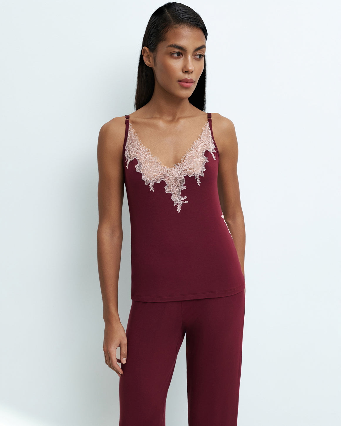 Effetto bamboo camisole pajama set 03163 – women's sleepwear, cherry lacquer
Woman wearing a burgundy lace-trimmed top and pants on a white background
