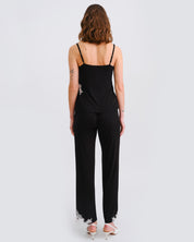 Effetto bamboo camisole pajama set 03163 – women's sleepwear, black
Woman wearing a black jumpsuit with lace details on a white background