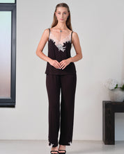 Effetto bamboo camisole pajama set 03163 – women's sleepwear, black
Woman wearing a black outfit with floral details in a minimalistic setting