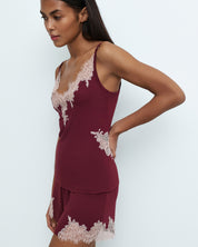 Effetto bamboo cami shorts set 03163 – women's sleepwear, cherry lacquer
Woman wearing a burgundy lace pajama set against a white background