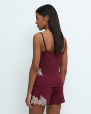 Effetto bamboo cami shorts set 03163 – women's sleepwear, cherry lacquer
Woman wearing a burgundy camisole and shorts set with lace details on a white background