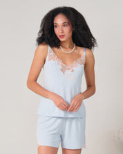 Effetto bamboo cami shorts set 03163 – women's sleepwear, icy blue
Woman wearing a light blue lace-trimmed top and shorts set against a plain background