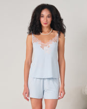 Effetto bamboo cami shorts set 03163 – women's sleepwear, icy blue
Woman wearing a light blue lace-trimmed top and shorts on a plain background