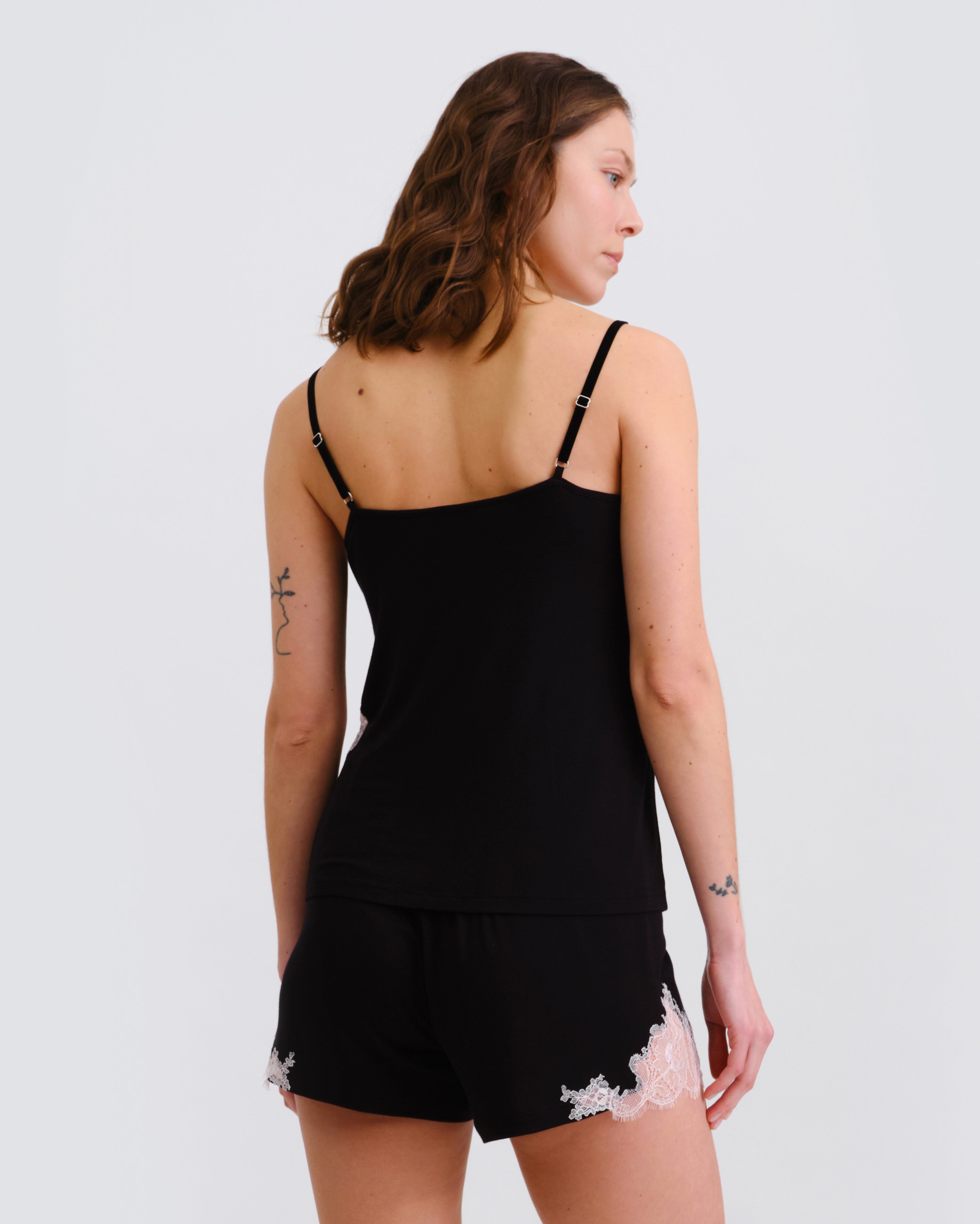 Effetto bamboo cami shorts set 03163 – women's sleepwear, black
Woman wearing a black lace-trimmed nightgown against a plain background